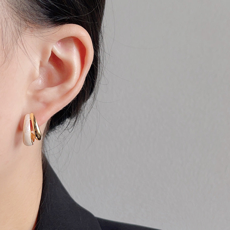 Model showcasing the retro 14k gold plated enamel stud earrings