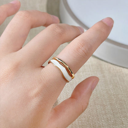 A pair of gold and white enamel rings from the set
