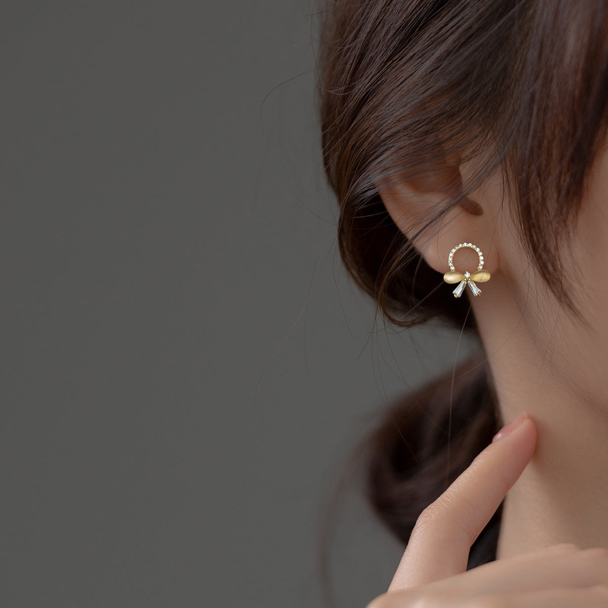 Model wearing the French-inspired zirconia butterfly knot earring