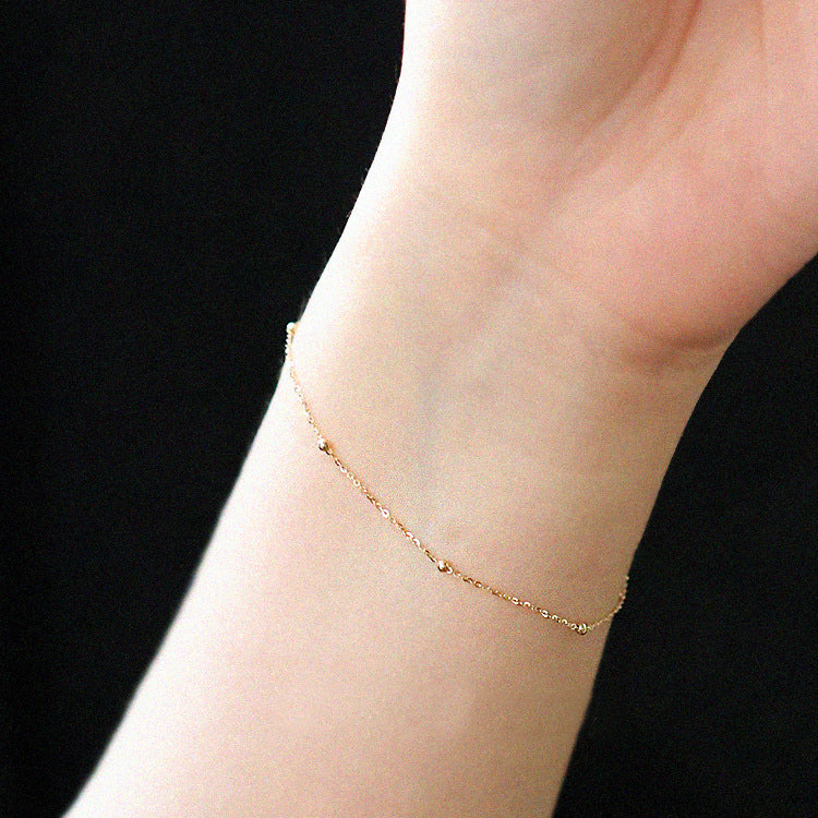 A close-up of the 925 sterling silver bead chain bracelet worn on a wrist.