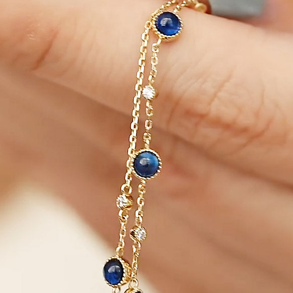 A woman wearing the gold-plated blue zircon bracelet to show its scale and style.