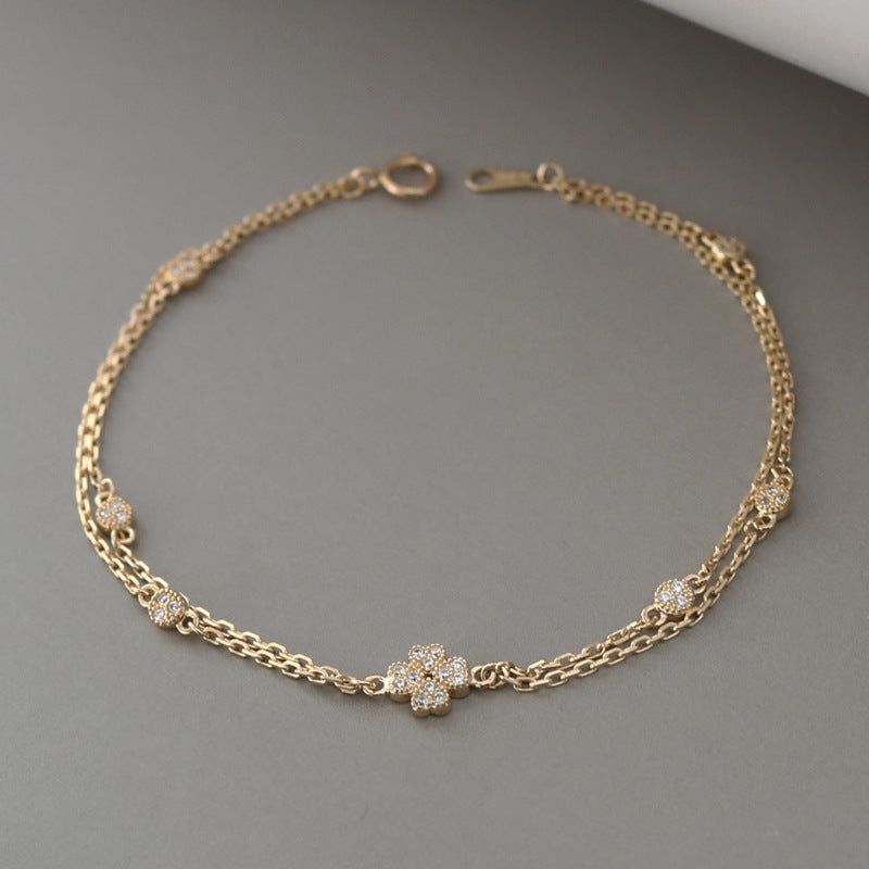 Close-up of the 18K gold plated double layer bracelet's clasp and chain detail.