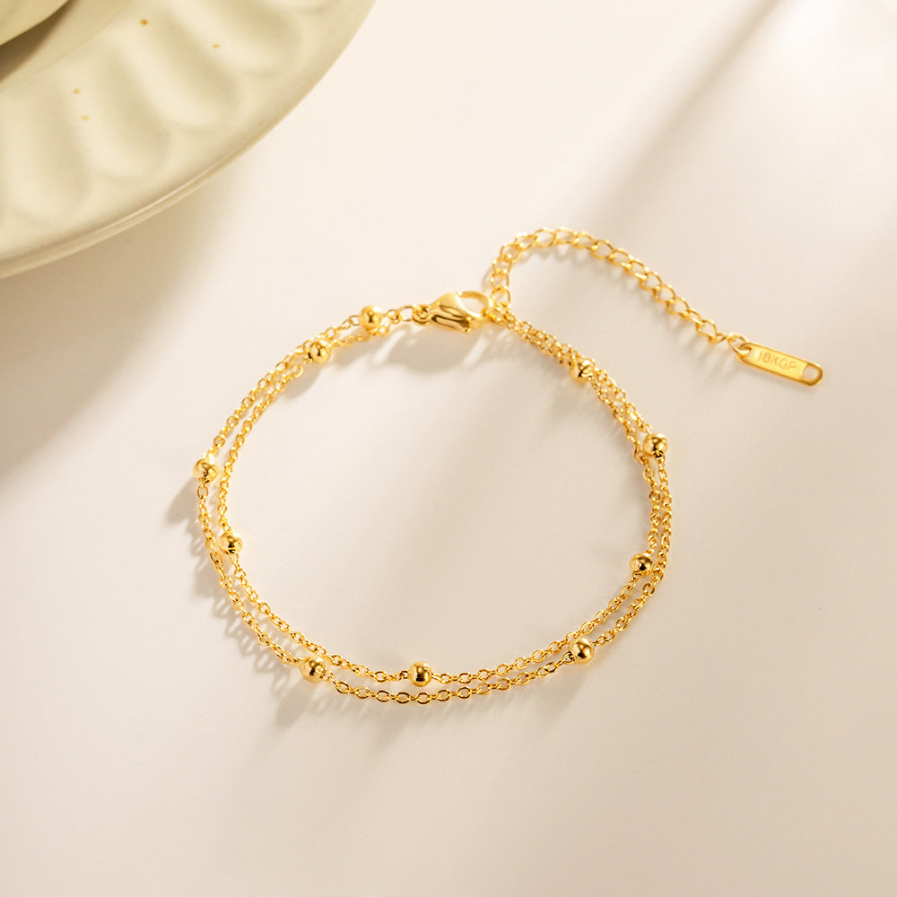 Detailed product view of the double-layered gold bead bracelet