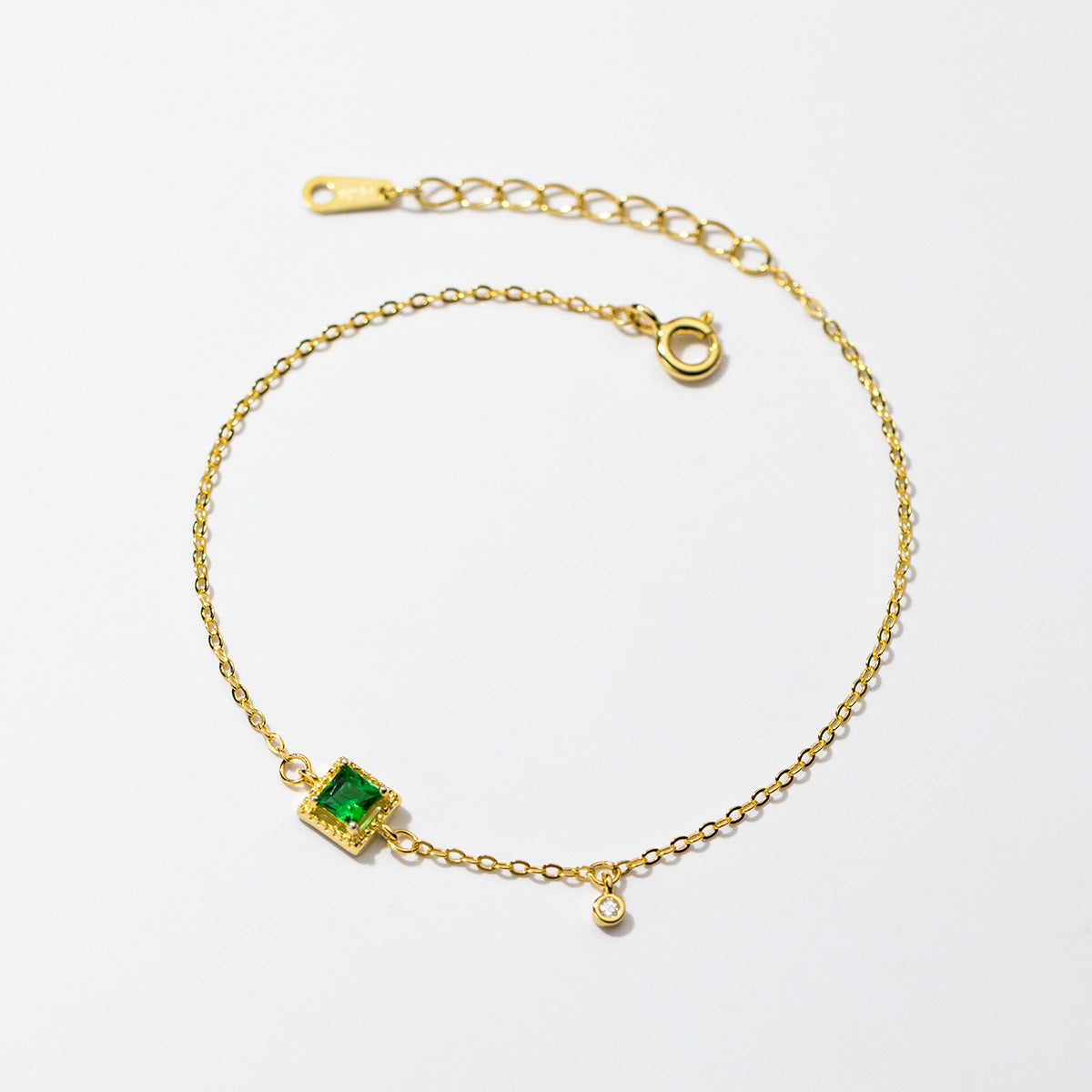 Detailed view of the green emerald zircon on the 18k gold plated bracelet