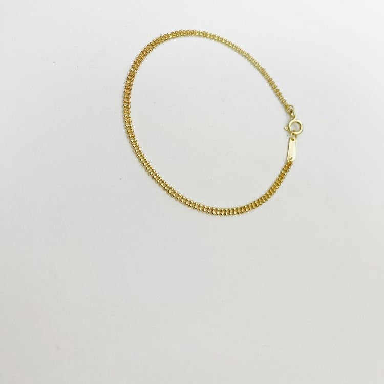 Detailed view of the textured beads and clasp on the 14K gold plated sterling silver bracelet.