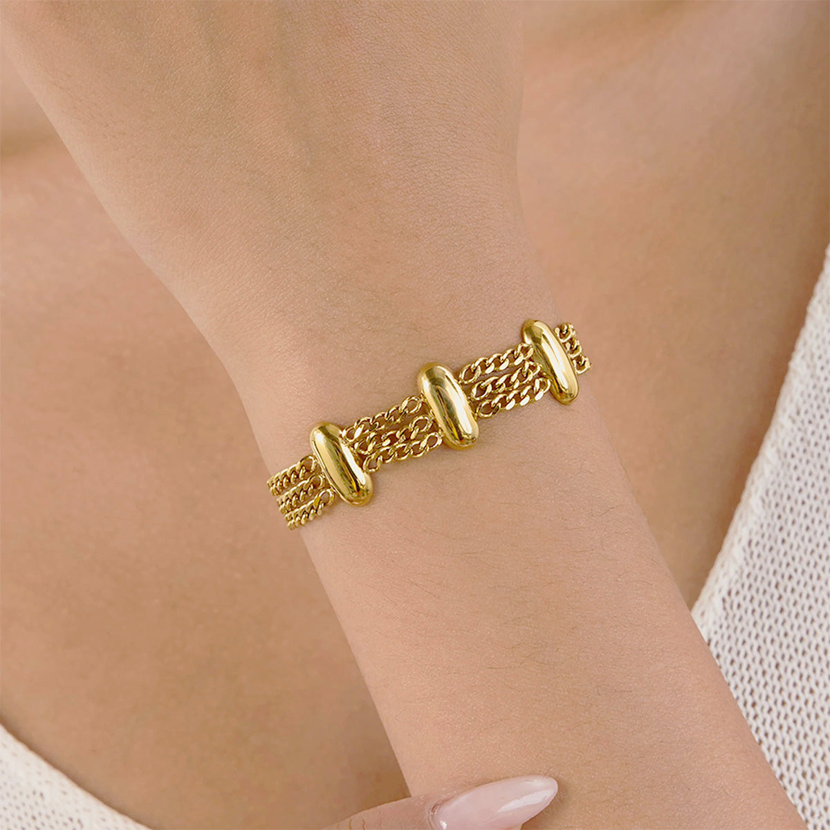 Model wearing the layered stainless steel gold bracelet set to showcase its modern fashion style.