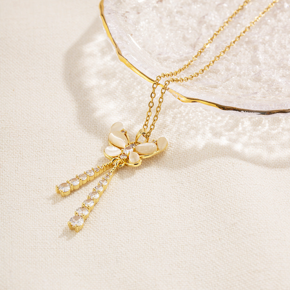 A beautiful gold butterfly necklace with sparkling crystal tassels