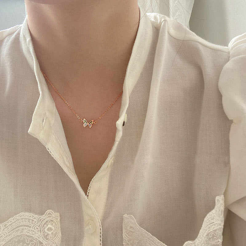 A woman wearing the sterling silver rose gold butterfly necklace, showcasing its elegant look.