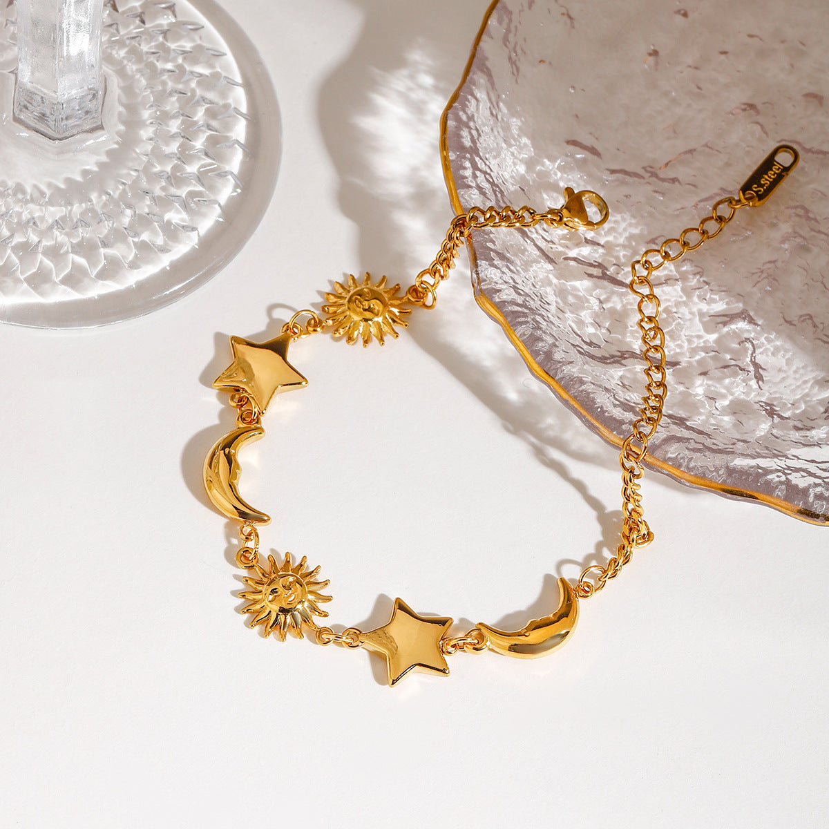 Close-up of the gold stainless steel moon star sun bracelet with celestial charms