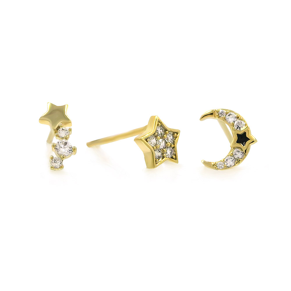 Close-up on the celestial designs of the three gold stud earrings