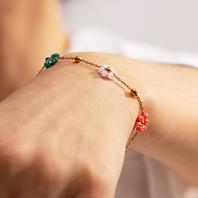 A model wearing the colorful floral charm bracelet set