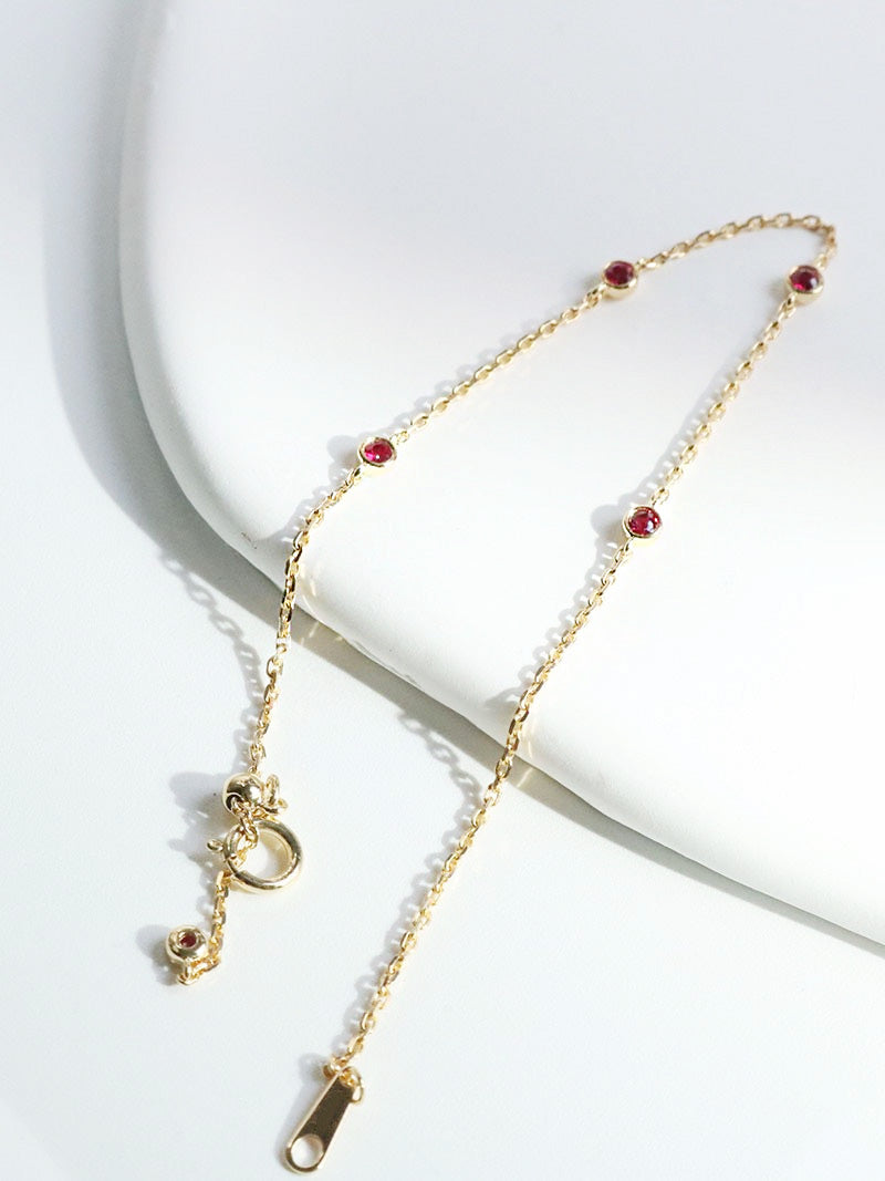 A model showcasing the 925 sterling silver bracelet with red gemstone