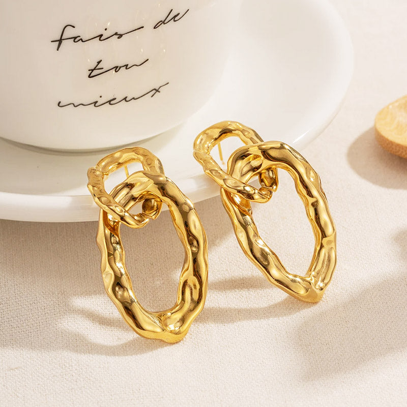 Lifestyle view of the chunky gold interlock earrings