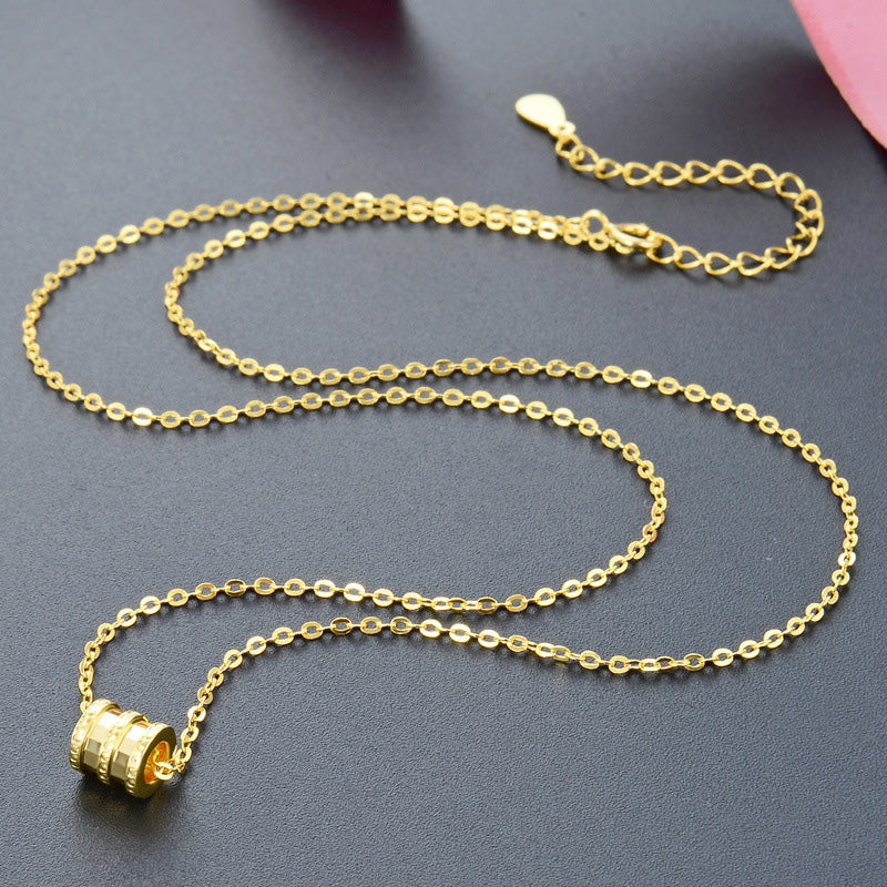 A model wearing the gold lucky tube bead necklace