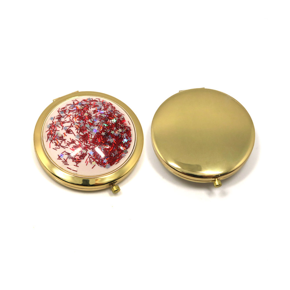 Gold compact mirror with swirling red and silver liquid glitter
