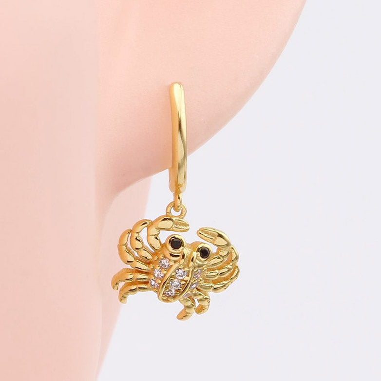 Gold crab earring with detailed gemstones