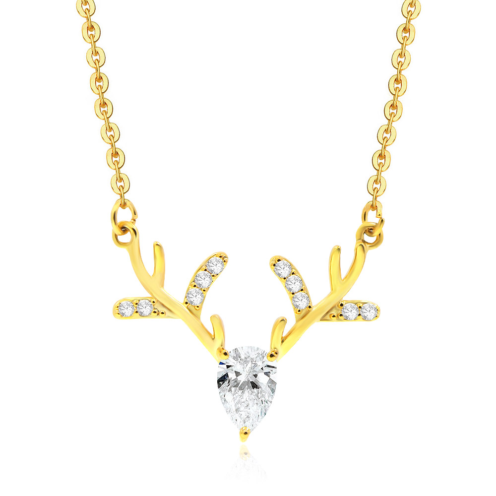 Detailed view of the gold deer antler pendant with a large teardrop cubic zirconia