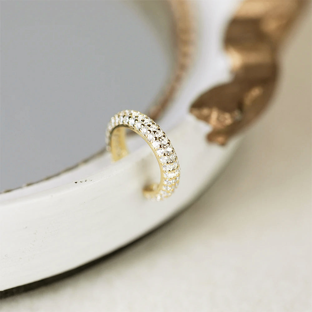Close-up of a single gold-plated zircon ear cuff earring.