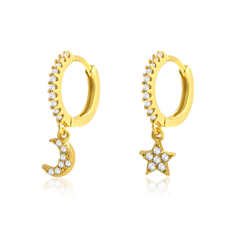 A close-up view of the diamond-encrusted hoops and celestial charms of the earrings.