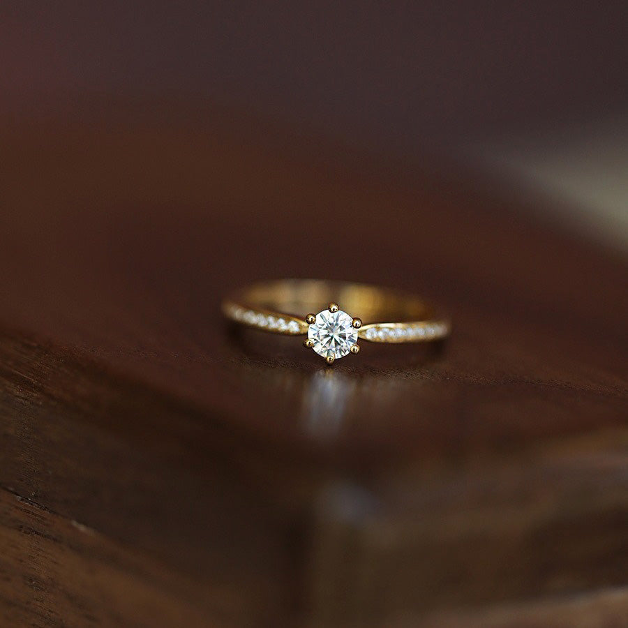 Detailed view of the six-prong setting on the gold-plated CZ ring