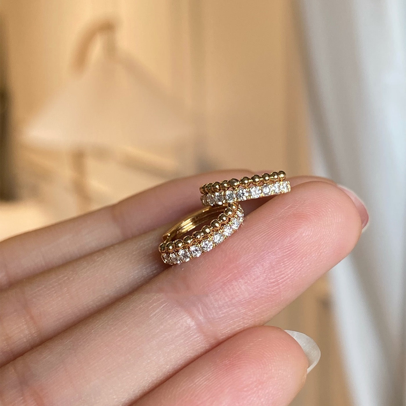 Side view of sparkling CZ beaded huggie hoop earrings in 18k gold plated 925 silver