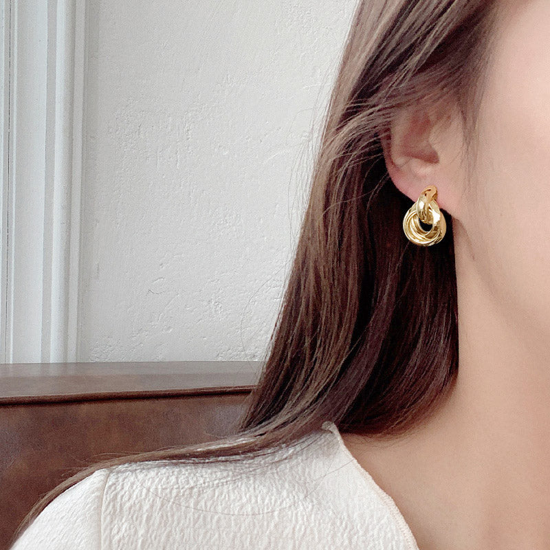 Model wearing the gold multi-layer stud earring