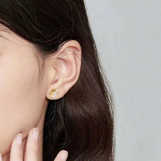 Model wearing the lucky money bag stud earring