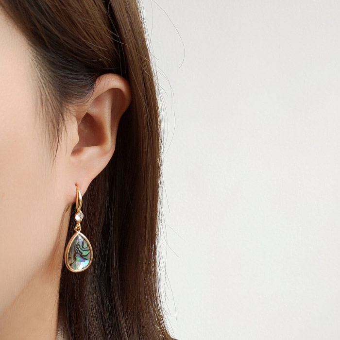 Model wearing the Shell Teardrop Fish Hook Earrings