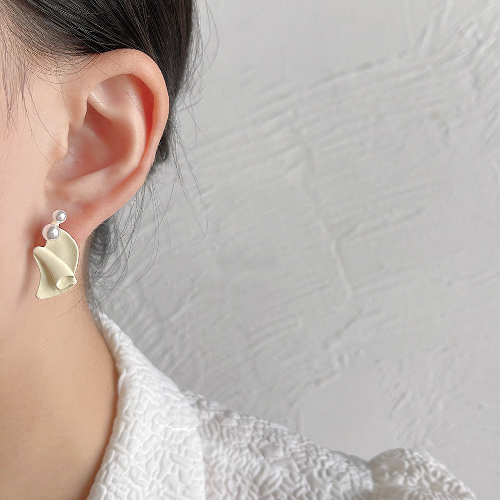 Model wearing one of the irregular pearl stud earrings