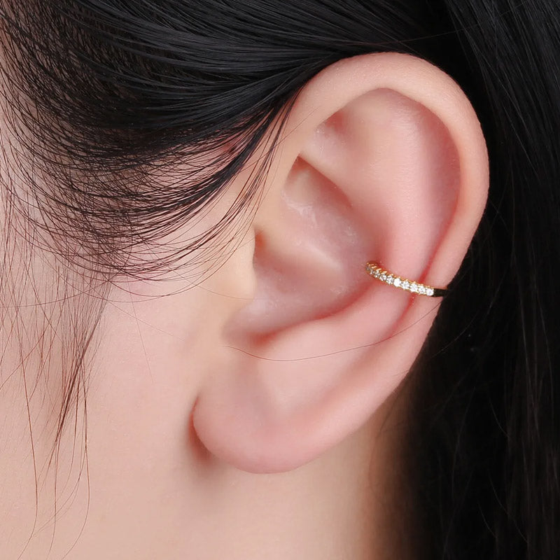 A gold CZ encrusted ear cuff worn on the ear cartilage for a stylish, non-pierced look.