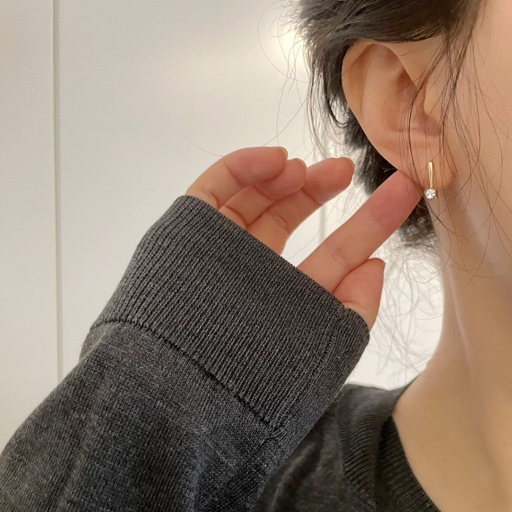 Model showcasing the elegant drape of the zircon threader earring.