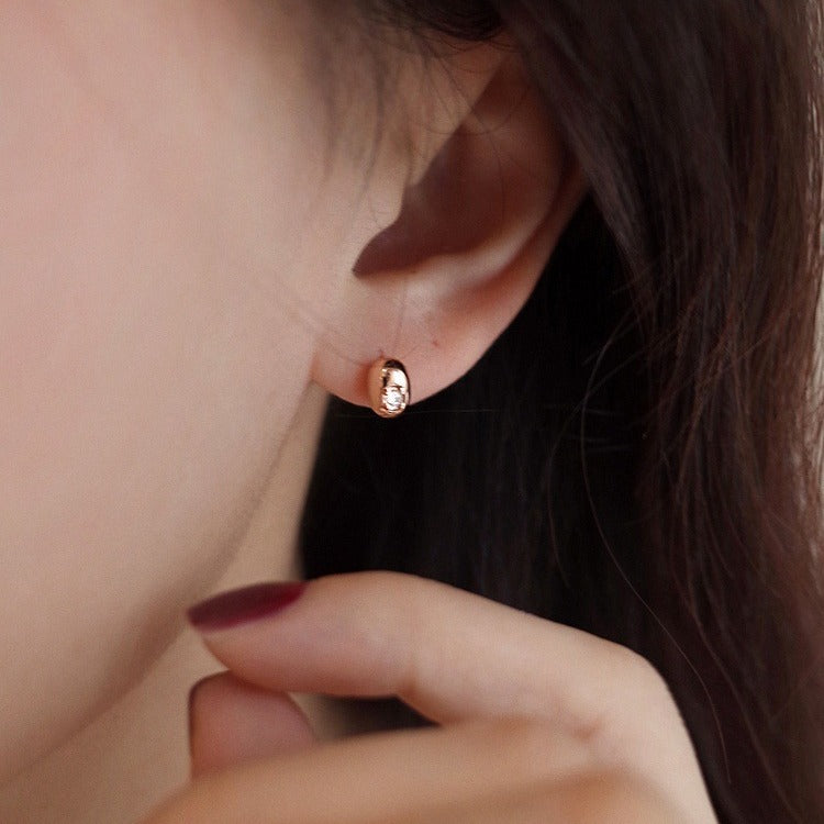 Model wearing the gold bean shaped stud earring
