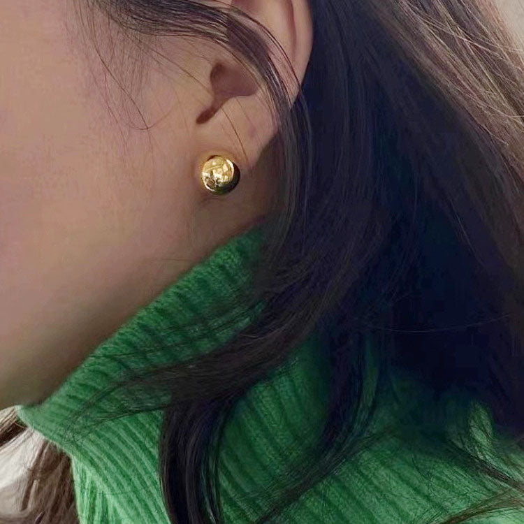 A model wearing the gold 12mm ball stud earring, showcasing its elegant look.