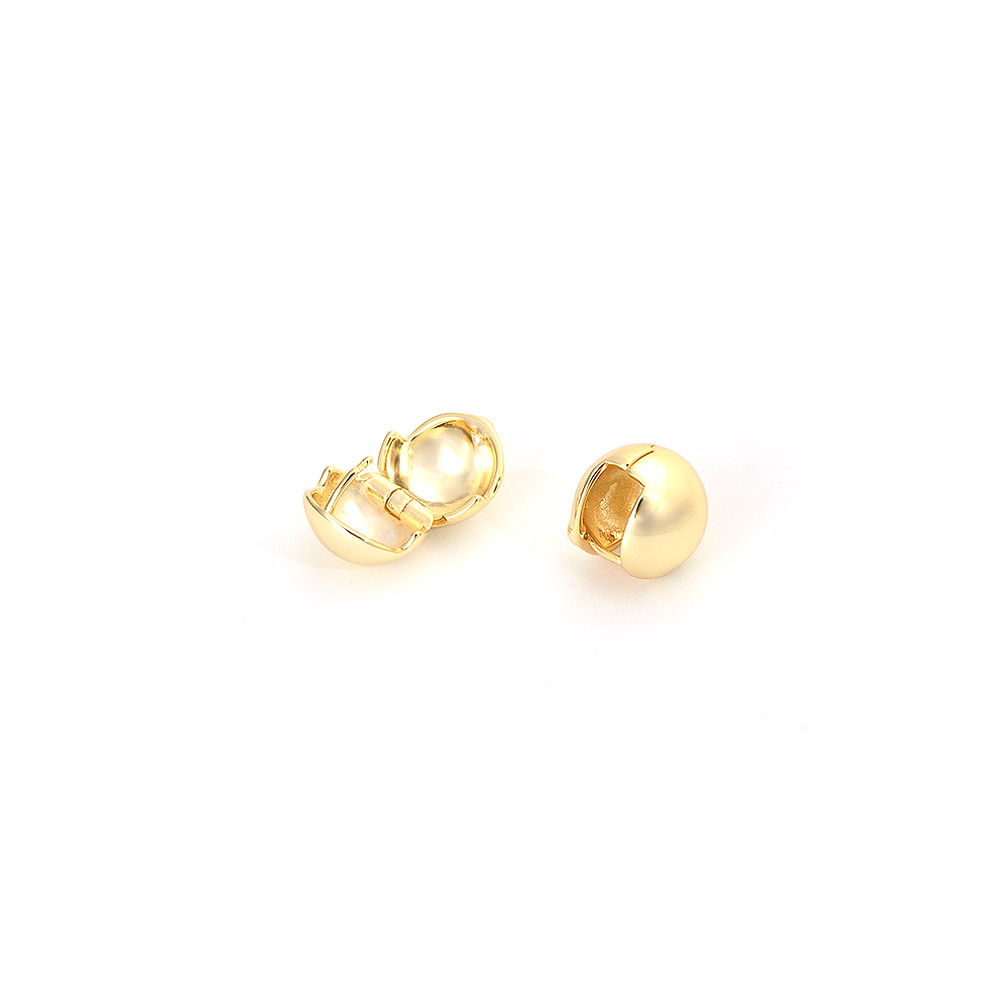 Detailed view of the gold hoop huggie earrings showing the front and back.