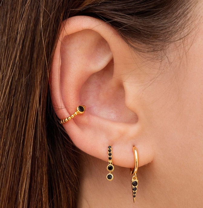Model showcasing the Black Drop Huggie Earrings Set