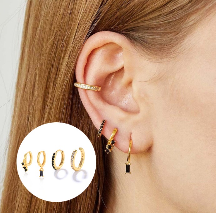 A model showcasing the Sterling Silver Black Cubic Zirconia Huggie Set