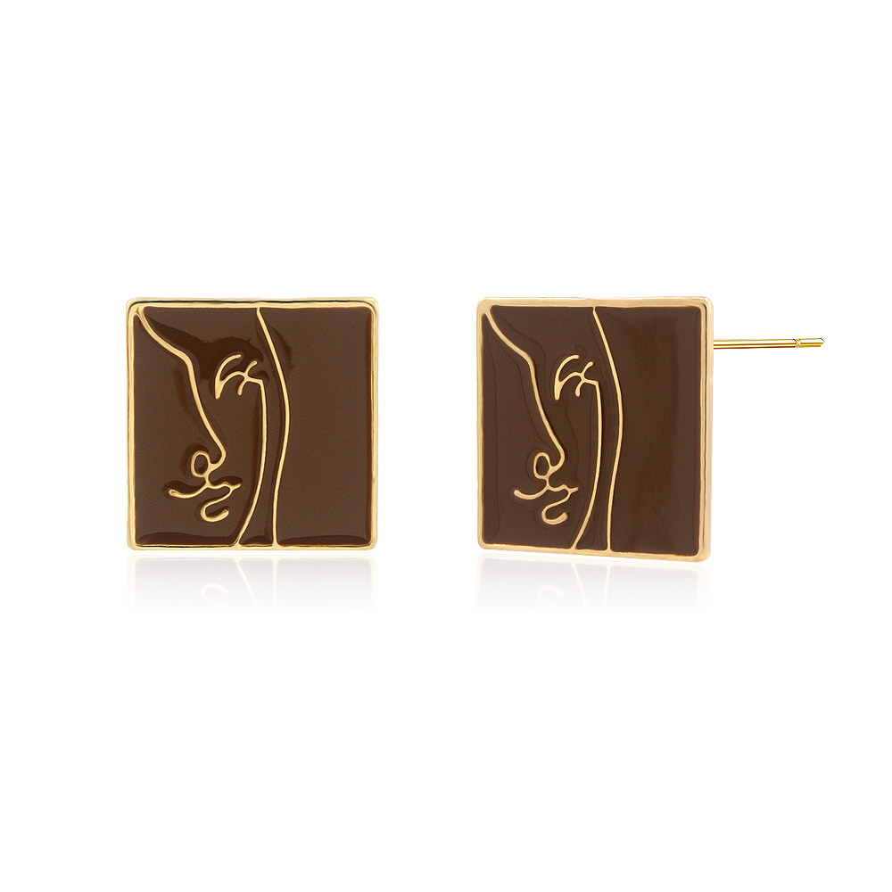 Detailed shot of the brown enamel face on the gold stud earring