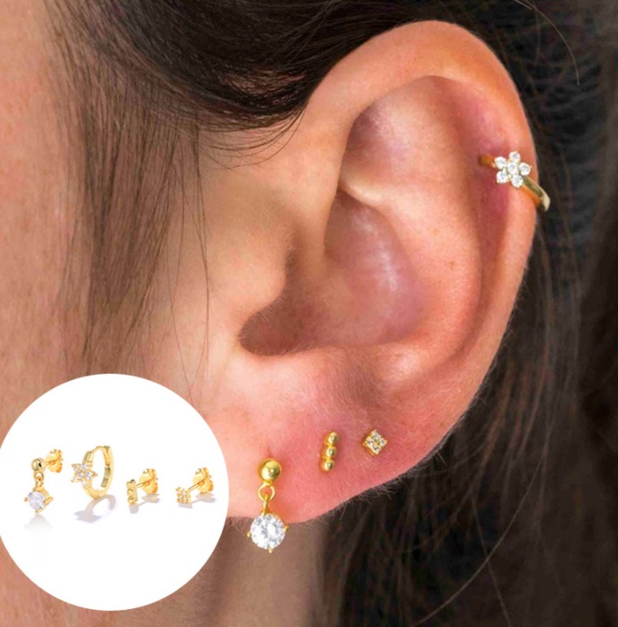 A model showcasing the versatile styling of the Cubic Zirconia Huggie Hoop Earrings Set.