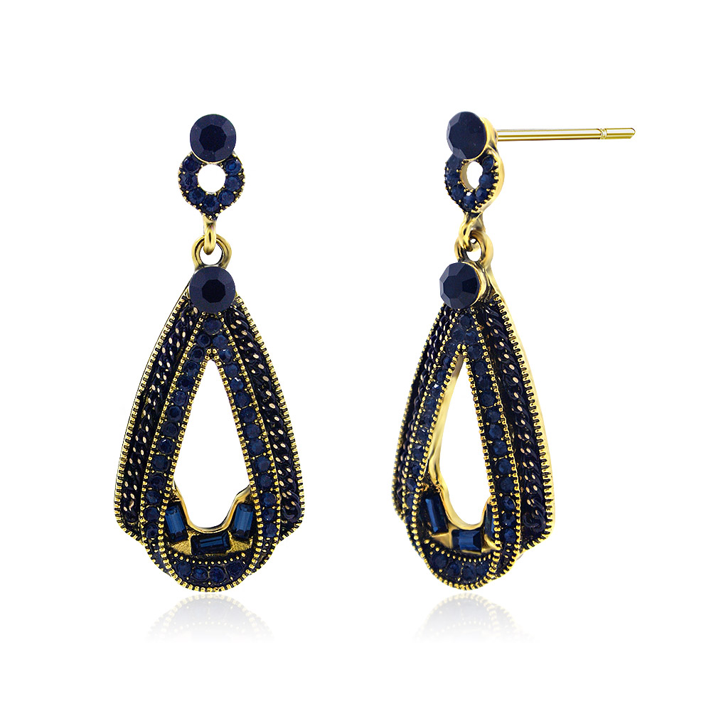 A close-up of the Montana Blue Chandelier earring showcasing its intricate gold-plated brass setting and sparkling dark blue gemstones.