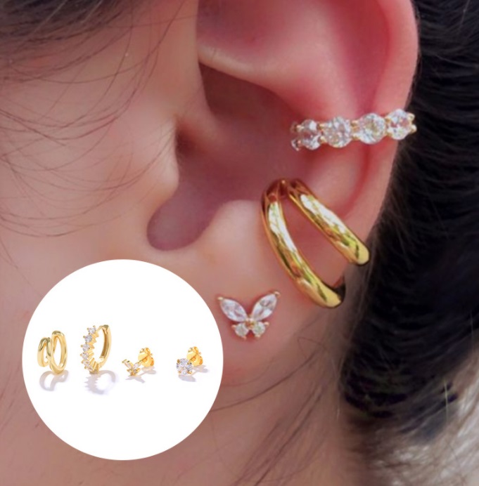 A model's ear adorned with the versatile set of 4 gold mini earrings