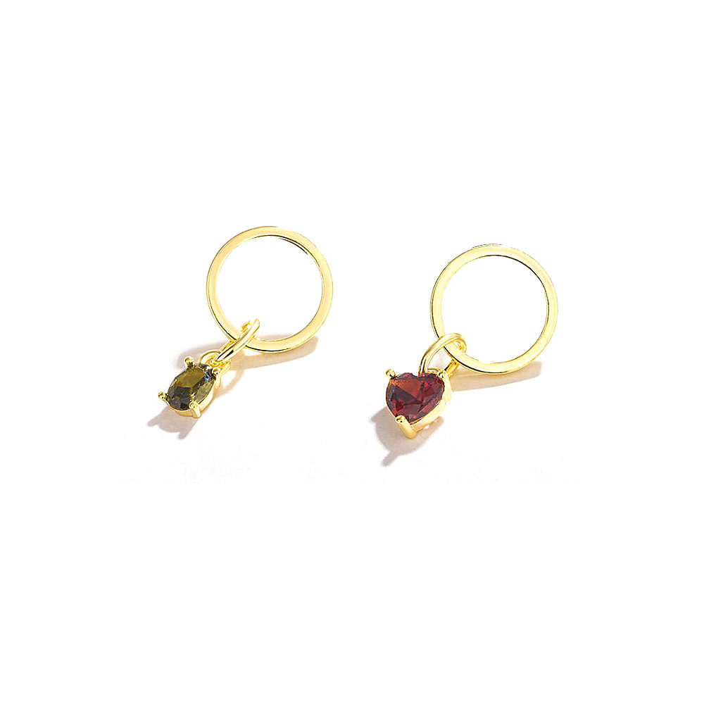 Close-up of the red and green gemstones on the gold-plated earrings