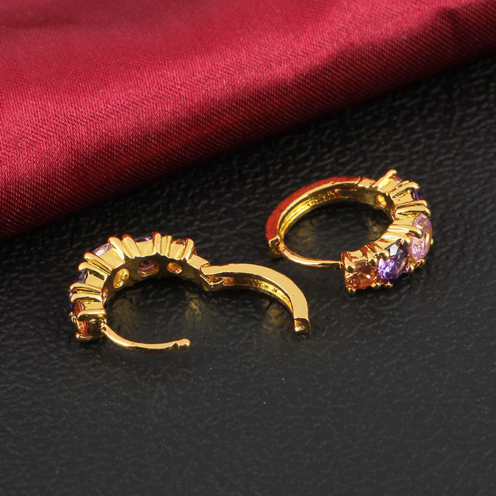 A pair of gold hoop earrings displaying a full spectrum of multicolored gemstones