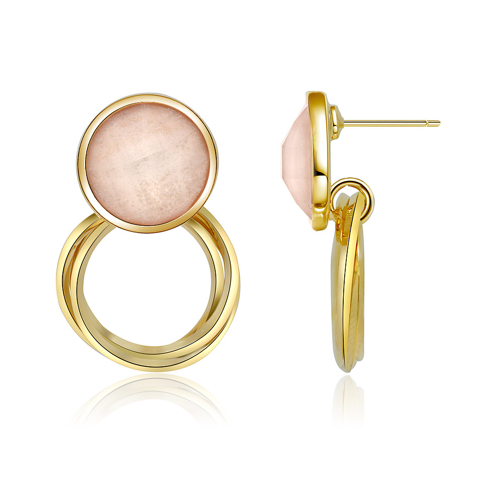 Detailed view of the pink resin stone on the gold hoop earring