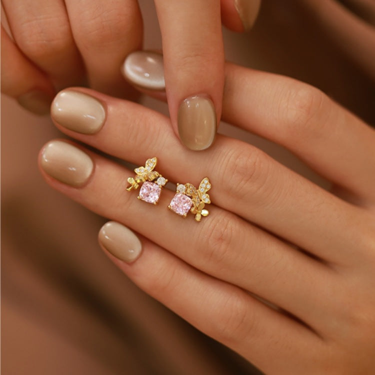 A model wearing the 18K gold plated butterfly earring with pink cubic zirconia.
