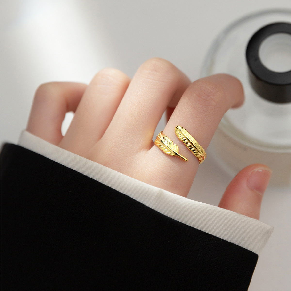 A model wearing the gold feather ring to showcase its elegant appearance on the hand.