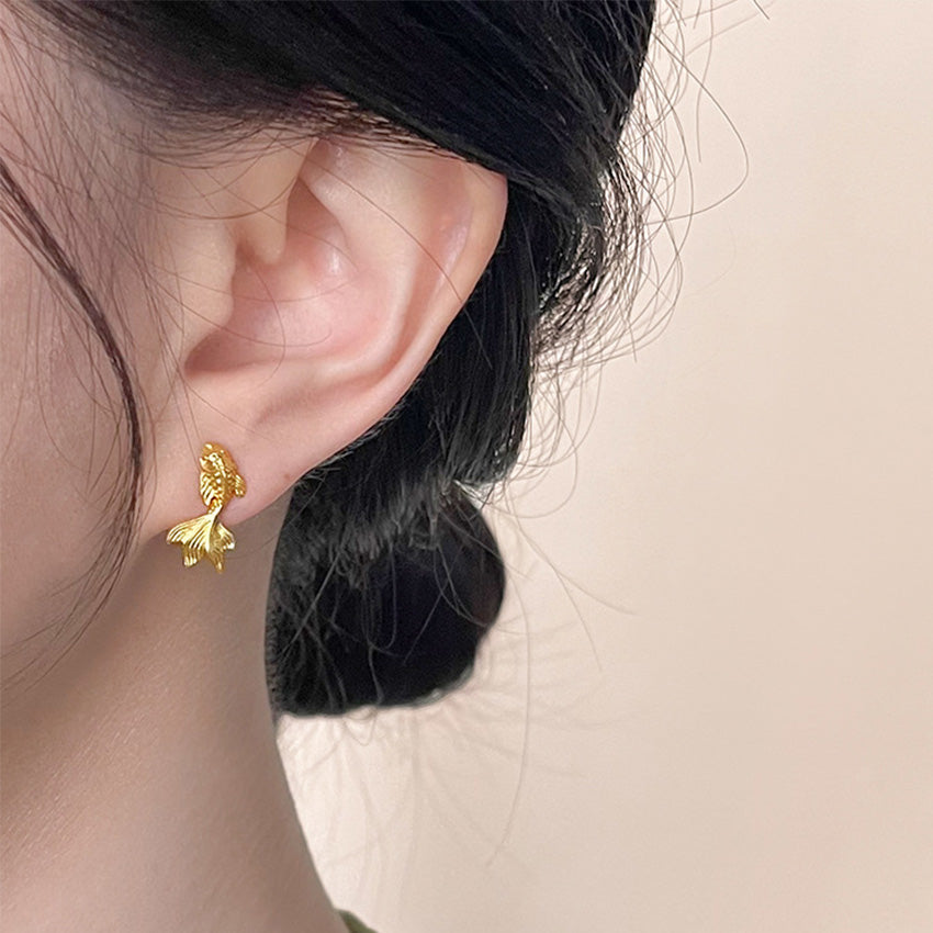 A woman models the elegant gold-plated brass Koi Fish earrings, perfect for Lunar New Year celebrations.