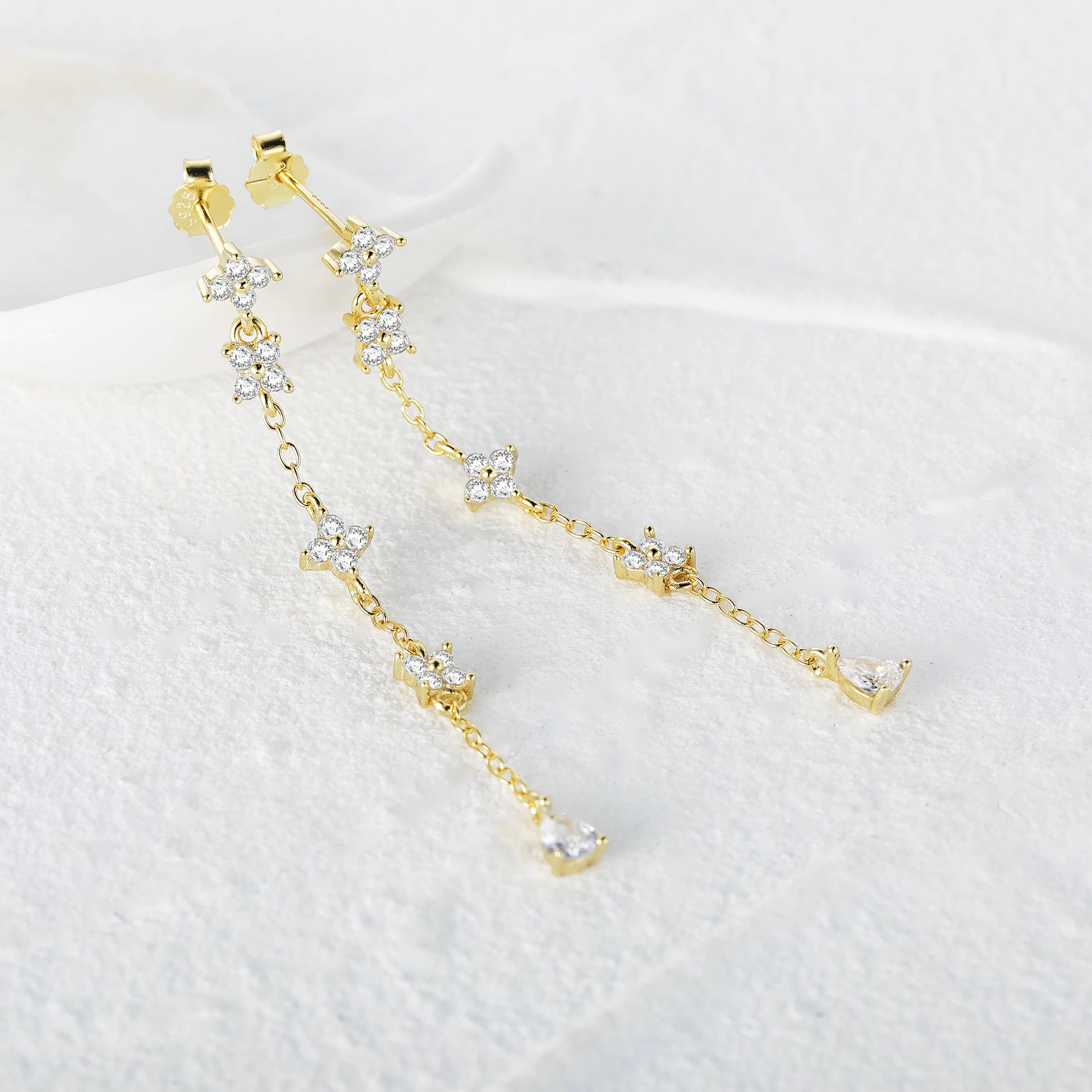 Detailed close-up of the 925 sterling silver flower tassel earrings in gold finish.