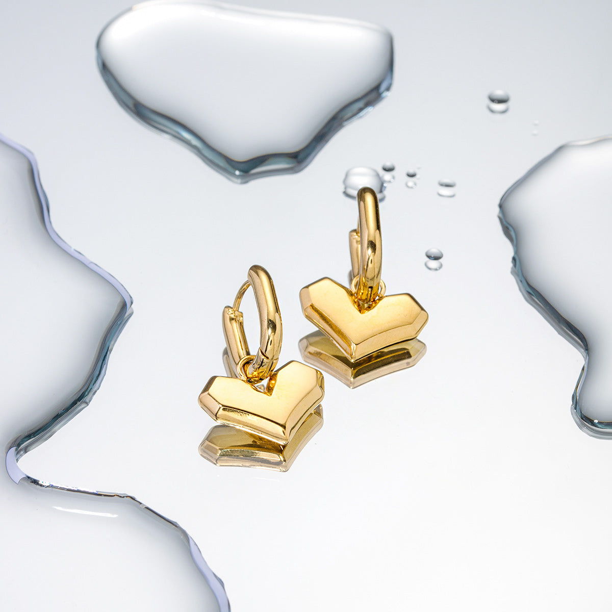 Waterproof gold huggie earrings with water splashes