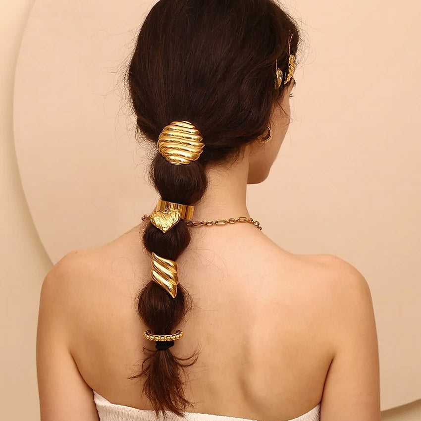A model with a braided hairstyle featuring the gold stainless steel round stripe hair tie.