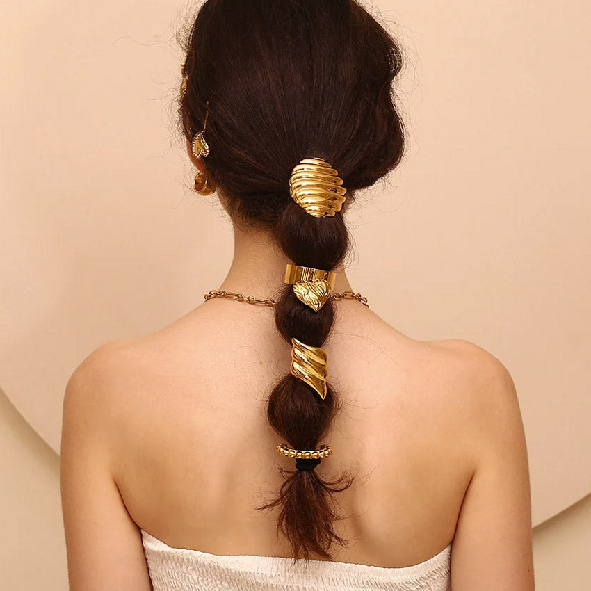 A model showcasing the gold hair cuff in a braided ponytail.